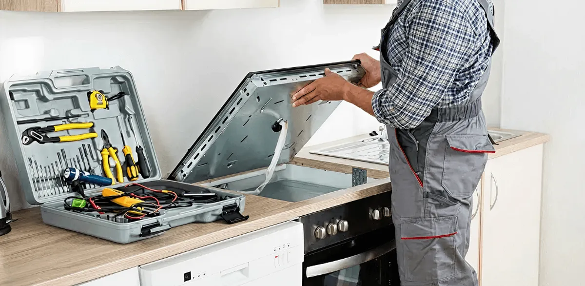 Handyman repairing a cooktop and checking wiring connections in Mesa, AZ