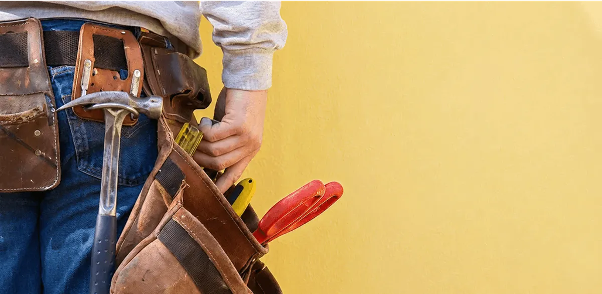 Handyman with tool belt ready for home repairs and maintenance in Mesa, AZ